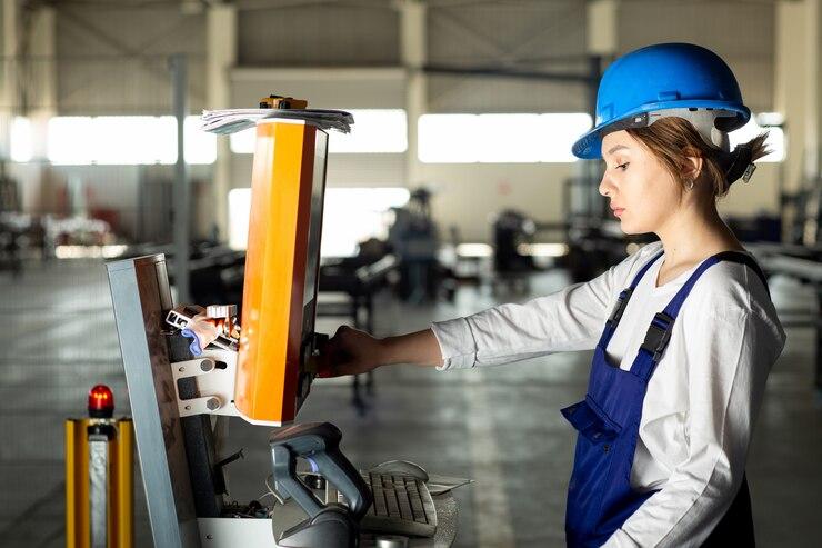 a-front-view-young-lady-in-blue-construction-suit-and-helmet-controlling-machines-in-hangar-during-daytime-buildings-architecture-construction_140725-15452.jpg